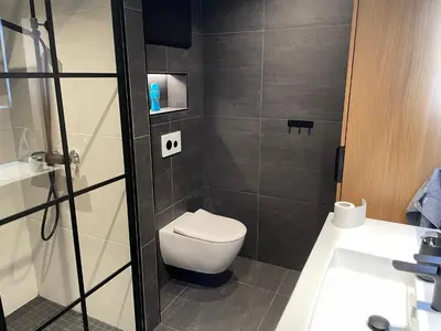 a small bathroom with a toilet and a sink at Olden apartments 2 in Stryn