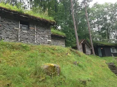 an old stone building with a grass roof on a hill at Voss/Bolstad: Peaceful countryside cabin/lodge in Bolstadøyri