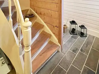a stairway with a wooden stair railing and a stair case at 8 person holiday home in MÅLØY-By Traum in Måløy