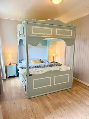 a bedroom with a bunk bed in a room at Finnegården Røros in Røros