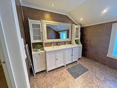 a bathroom with a sink and a mirror at Finnegården Røros in Røros