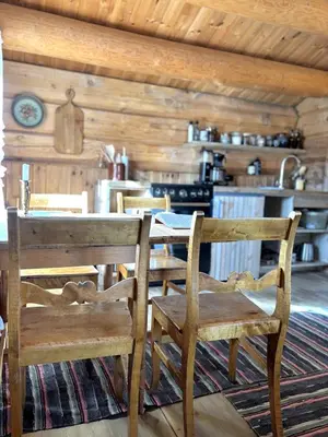 a dining room with a table and two chairs at Stallen - koselig lite hus på gårdstun in Skjåk