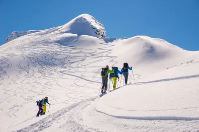 a group of people hiking up a snow covered mountain at Stallen - koselig lite hus på gårdstun in Skjåk