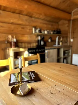 a bottle of oil sitting on top of a wooden table at Stallen - koselig lite hus på gårdstun in Skjåk