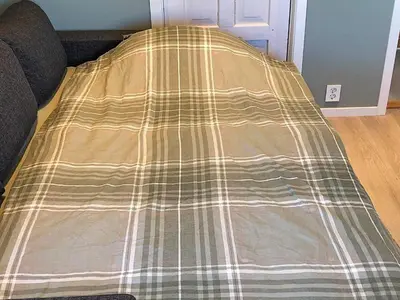 a blanket on top of a bed in a room at 5 person holiday home in Svelgen-By Traum in Svelgen