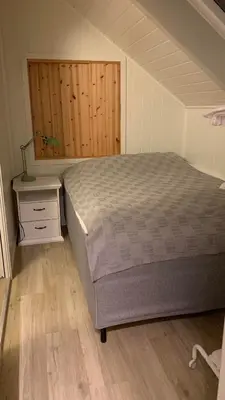a bedroom with a bed and a nightstand and a bed sidx sidx sidx sidx at Bright and cozy apartment 1.5km from city centre in Aurland