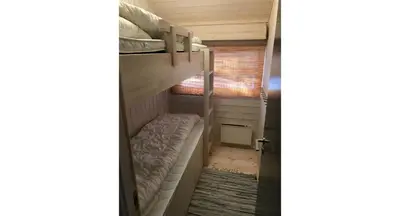 a bunk bed in a room with a window at Venehovda - cabin at 1000 masl in Ål