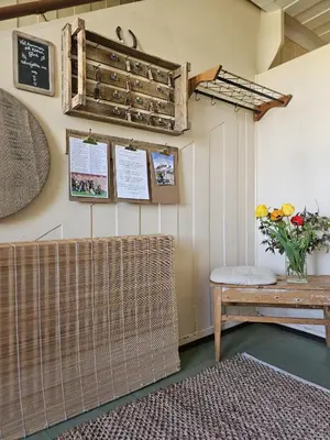 a room with a table and a vase of flowers at Fokhol Gård Gjestehus in Stange