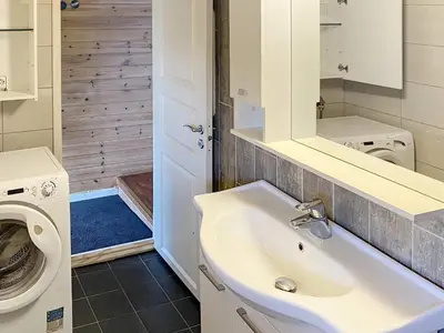 a bathroom with a sink and a washing machine at 4 person holiday home in LINDÅS-By Traum in Lindås
