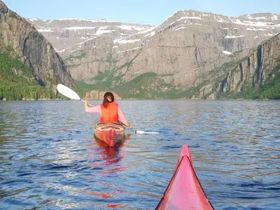 a woman is in a kayak on a lake at 4 person holiday home in LINDÅS-By Traum in Lindås