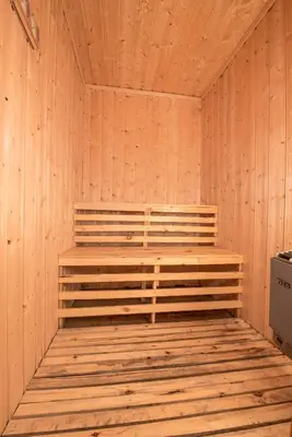 a wooden sauna with a wooden bench in it at Festly in Ringsaker
