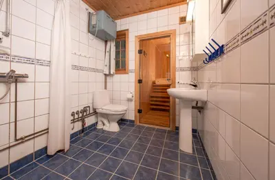 a bathroom with a toilet and a sink at Festly in Ringsaker