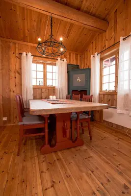 a dining room with a large wooden table in a cabin at Festly in Ringsaker