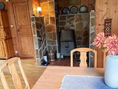 a living room with a stone fireplace and two chairs at 7 person holiday home in STRYN-By Traum in Stryn