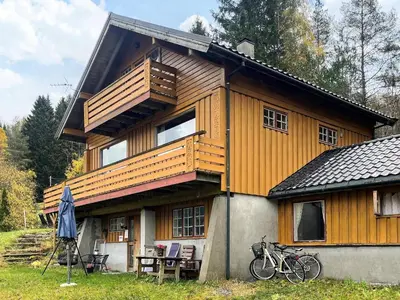 a large wooden house with bikes parked in front of it at 7 person holiday home in STRYN-By Traum in Stryn