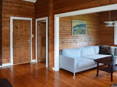 a living room with a white couch and wooden walls at 4 person holiday home in Utvik-By Traum in Utvik