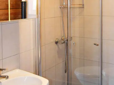 a shower with a glass door next to a sink at 4 person holiday home in Utvik-By Traum in Utvik
