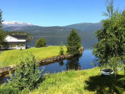 a house on a hill next to a lake at 6 person holiday home in TYSSE-By Traum in Tysse
