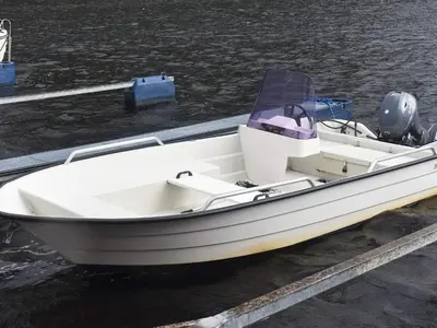 a white boat is docked at a dock at 6 person holiday home in TYSSE-By Traum in Tysse