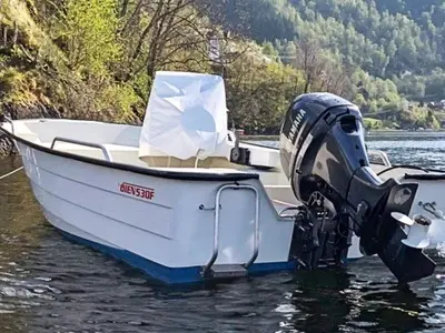 a white boat sitting on top of a body of water at 6 person holiday home in TYSSE-By Traum in Tysse
