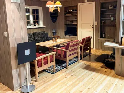a living room with a wooden table and chairs at 2 person holiday home in STRYN-By Traum in Stryn