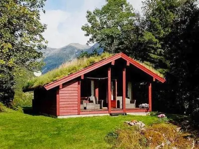 a small red cabin with a grass roof at 6 person holiday home in olden-By Traum in Olden