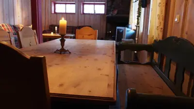 a candle sitting on top of a wooden table at Hemsedal Høyfjellssenter in Hemsedal