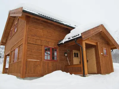 a log cabin with snow on the roof at Hemsedal Høyfjellssenter in Hemsedal