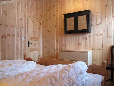 a bedroom with a bed and a television on the wall at Hemsedal Høyfjellssenter in Hemsedal