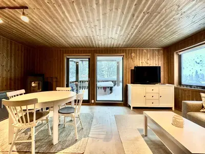 a living room with a table and a couch at Modern ski-in out apartment at Sjusjøen in Sjusjøen