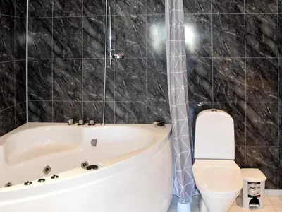 a bathroom with a tub and a toilet at 6 person holiday home in SANDANE-By Traum in Sandane