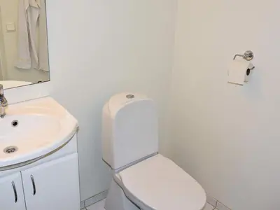 a bathroom with a white toilet and a sink at 6 person holiday home in SANDANE-By Traum in Sandane