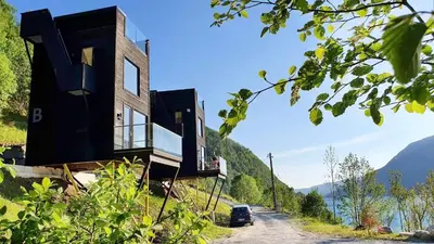 a house on the side of a hill with a view at Mikrohyttene i Åkrafjorden in Etnesjøen