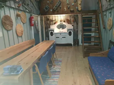 a room with a table and a stove in a house at Havgløtt in Oksvoll