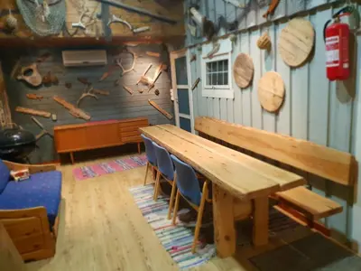 a dining room with a wooden table and chairs at Havgløtt in Oksvoll