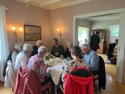 a group of older people sitting around a table at Sjarmerende hus med veldig stort uteareal. in Brekstad