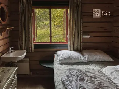 a bedroom with a bed and a sink and a window at Cozy cabin at Beitostølen with sauna, hot tub & fireplace in Beitostøl