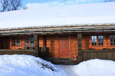a wooden cabin with snow on the roof at Cozy cabin at Beitostølen with sauna, hot tub & fireplace in Beitostøl