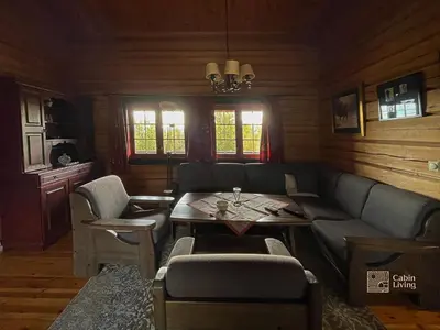 a living room with a couch and a table at Cozy cabin at Beitostølen with sauna, hot tub & fireplace in Beitostøl