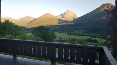 a wooden bench with a view of a mountain at Hatlen View in Isfjorden