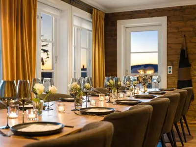 a long table with chairs and plates and glasses at Budor - Løvsangeren 7 - 60 min OSL - Badstu - Badestamp - 7 Soverom3 bad in Nordset