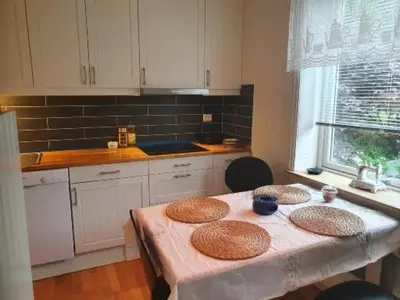 a kitchen with a table with three baskets on it at Sjarmerende feriehus i Olden rett ved fjorden in Stryn