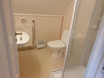 a small bathroom with a toilet and a sink at Sjarmerende feriehus i Olden rett ved fjorden in Stryn