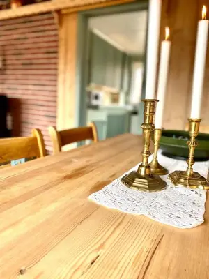 two candles sitting on top of a wooden table at Stort og autentisk hus i Skjåk - kort vei til Lom! in Skjåk