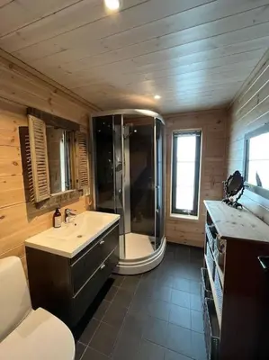 a bathroom with a tub and a sink and a shower at Cabin in beautiful surroundings at Harpefossen in Nordfjordeid