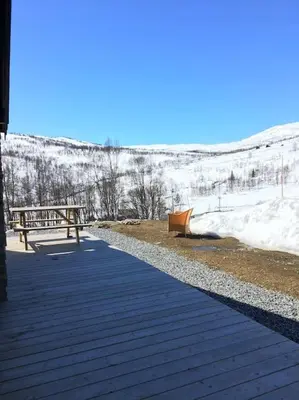 a walkway with a bench and snow on a hill at Holiday cottage with 4 bedroom on 145m² in Sogndal in Sogndal