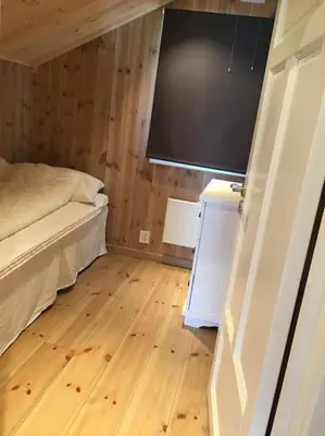 a small room with a bed and a television at Holiday cottage with 4 bedroom on 145m² in Sogndal in Sogndal
