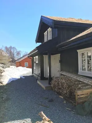 a house with a pile of logs in front of it at Holiday cottage with 4 bedroom on 145m² in Sogndal in Sogndal