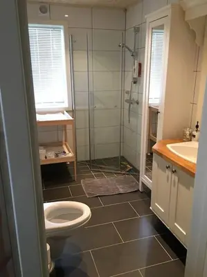 a bathroom with a shower and a toilet and a sink at Holiday cottage with 4 bedroom on 145m² in Sogndal in Sogndal