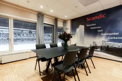 a conference room with a black table and chairs at Scandic Lerkendal in Trondheim